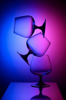 Three empty glasses in bicolor light