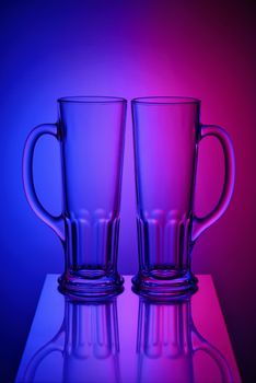 Two empty glasses in bicolor light