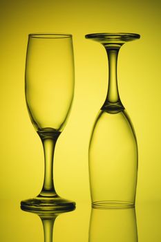 Two empty glasses in yellow light