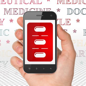 Health concept: Hand Holding Smartphone with  red Pills Blister icon on display,  Tag Cloud background, 3D rendering