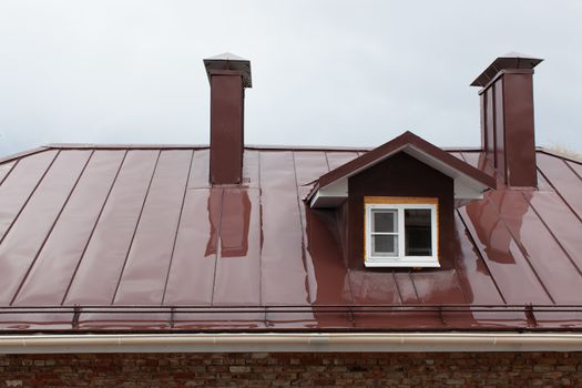 Wet metal roof of the building in the ambassador of a rain