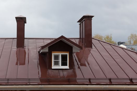 Wet metal roof of the building in the ambassador of a rain