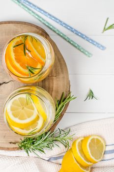 Detox fruit infused flavored water. Refreshing summer homemade cocktail with lemon and orange