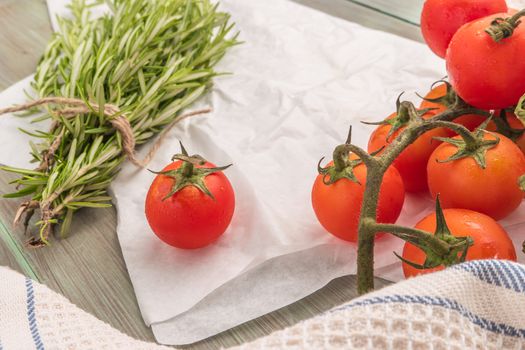 Organic cherry tomatoes with rosemary on wrinkled paper