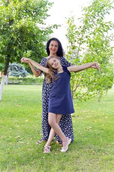 Playing mother and daughter in summer on green background
