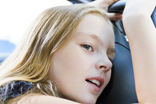 Portrait of cute tired girl with blond hair