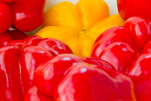 Photo of red and yellow raw pepper on white background