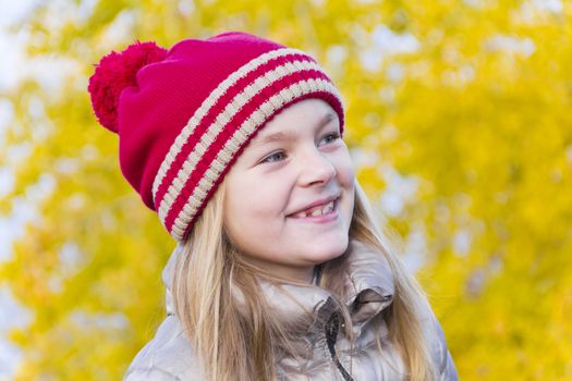 Portrait of cute smiling girl in red hat