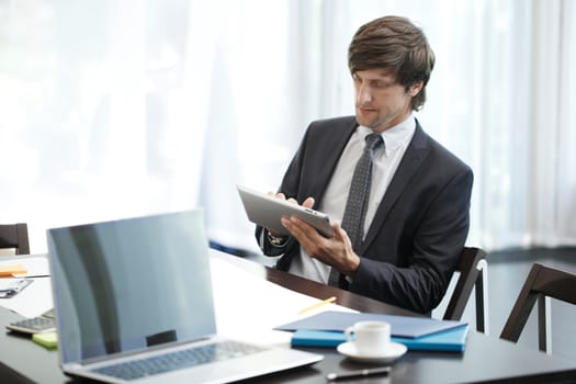 Business man with tablet computer in office