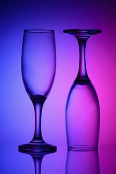 Two empty glasses in bicolor light
