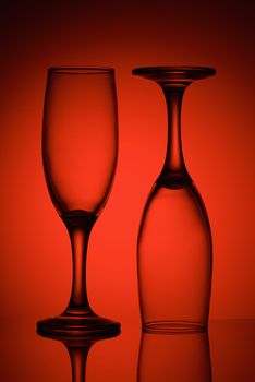 Two empty glasses in red light