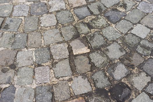 Old  traditional european style cobblestone road texture background with granite blocks, stones and brickwork pattern