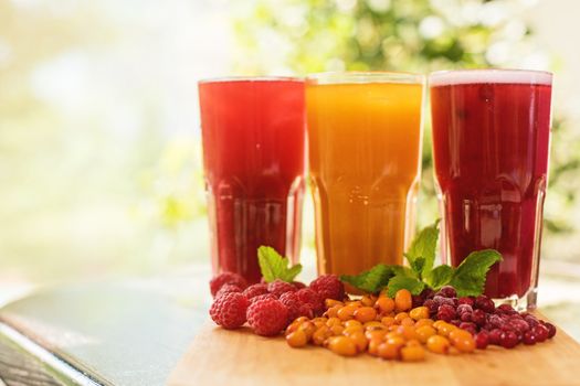 set of fruit non-alcoholic drink with cranberries raspberries and sea buckthorn