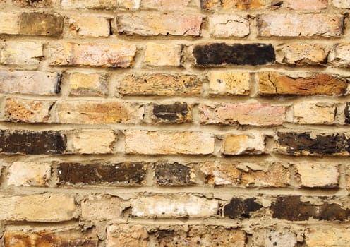 Closeup on old urban brick wall with different tiles