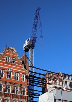 Construction crane with old and new buildings