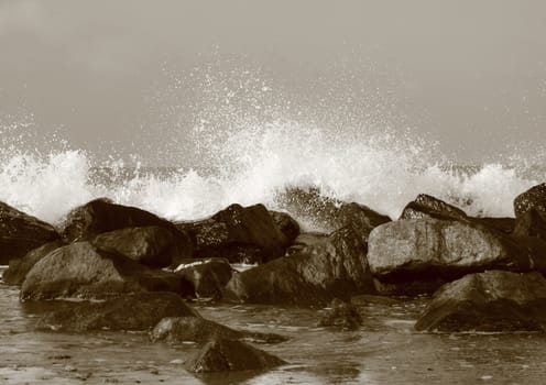 Silent water behind large rocks at beach