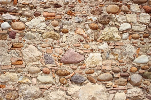 Unstructered wall with rocks tiles and cement