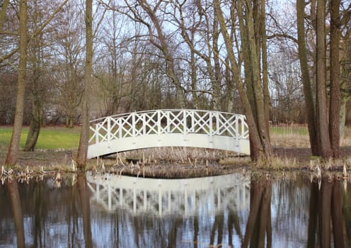 White bridge at small pond in park