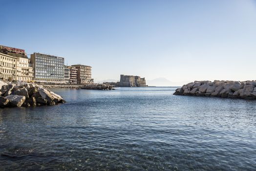 Seafront Promenade with the castle on the sea in Naples, Italy