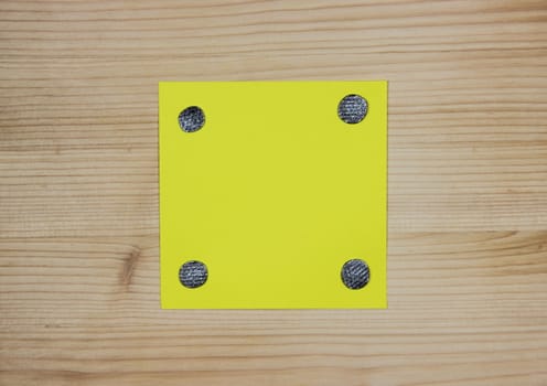 Yellow note attached to wood with nails