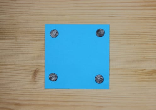 Blue note attached to wood with nails