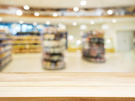 Wooden board empty table in front of blurred background. Perspective light wood over blur in supermarket - can be used for display or montage your products. Mock up for display of product.