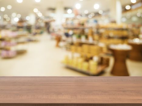 Wooden board empty table in front of blurred background. Perspective dark wood over blur in supermarket - can be used for display or montage your products. Mock up for display of product.