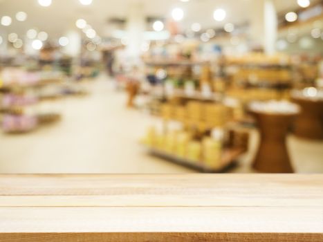 Wooden board empty table in front of blurred background. Perspective light wood over blur in supermarket - can be used for display or montage your products. Mock up for display of product.