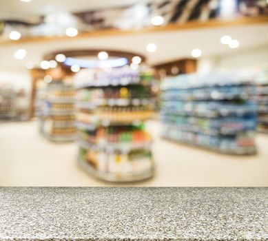 Marble board empty table in front of blurred background. Perspective marble over blur in supermarket - can be used for display or montage your products. Mock up for display of product.