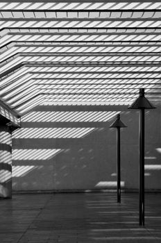 Modern courtyard in black and white, strong contrast between shade and sunlight