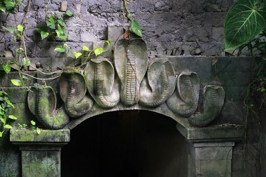Arch decorated with a bas-relief of cobras. Bali, Indonesia