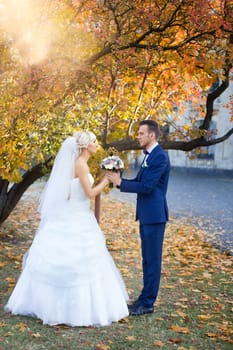 Bride and groom embrace on a walk in the countryside for a walk