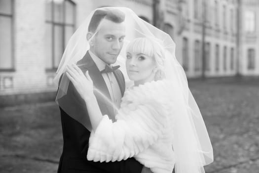 Bride and groom embrace on a walk in the countryside for a walk