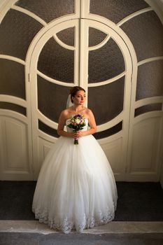 Portrait of a bride with red hair on the wedding day