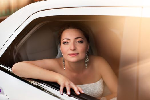 Portrait of a bride with red hair on the wedding day