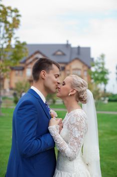 wedding couple hugging and kissing in a private moment of joy