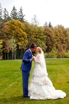 wedding couple hugging and kissing in a private moment of joy