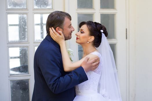 Groom in white shirt kissing bride hand. Very gentle photo