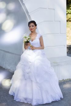 Brunette bride in a white dress expensive