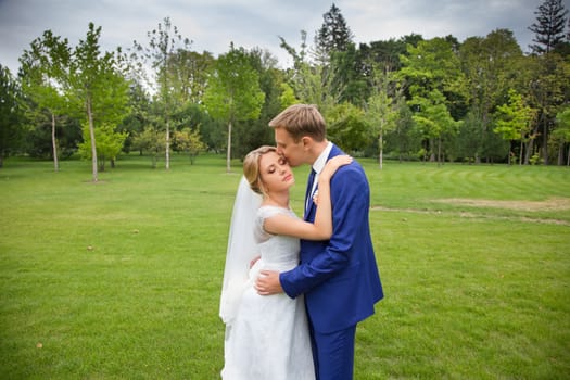 The groom gently hugged the bride