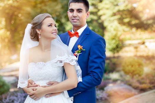 Funny bride and groom on a summer day in the park