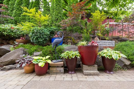 House Garden Backyard with hardscape and softscape with plants trees pavers stones colorful pots containers in landscaping