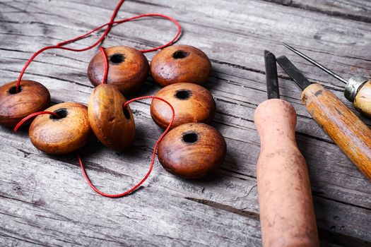 Accessories craft with wooden beads and tools on wooden background