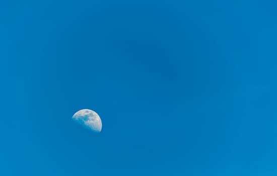 Half moon on blue sky in daytime