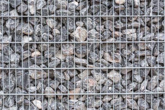 Gabion filled with thick stones; Metal Stone basket with large natural stones for external landscaping.
