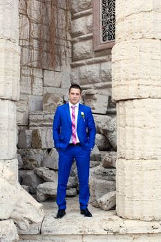 Elegant luxury wedding blue suit with bowtie on hanger tree closeup