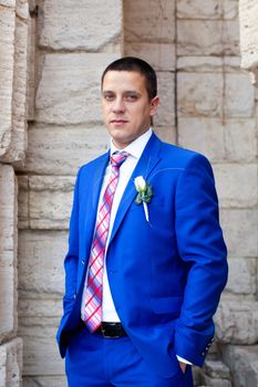 Elegant luxury wedding blue suit with bowtie on hanger tree closeup