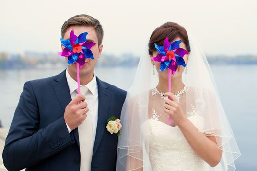 groom gently touched to the bride on a pier near the sea