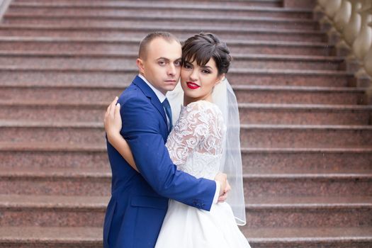 Bride and groom posing in the rain