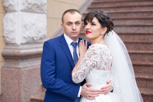 Bride and groom posing in the rain